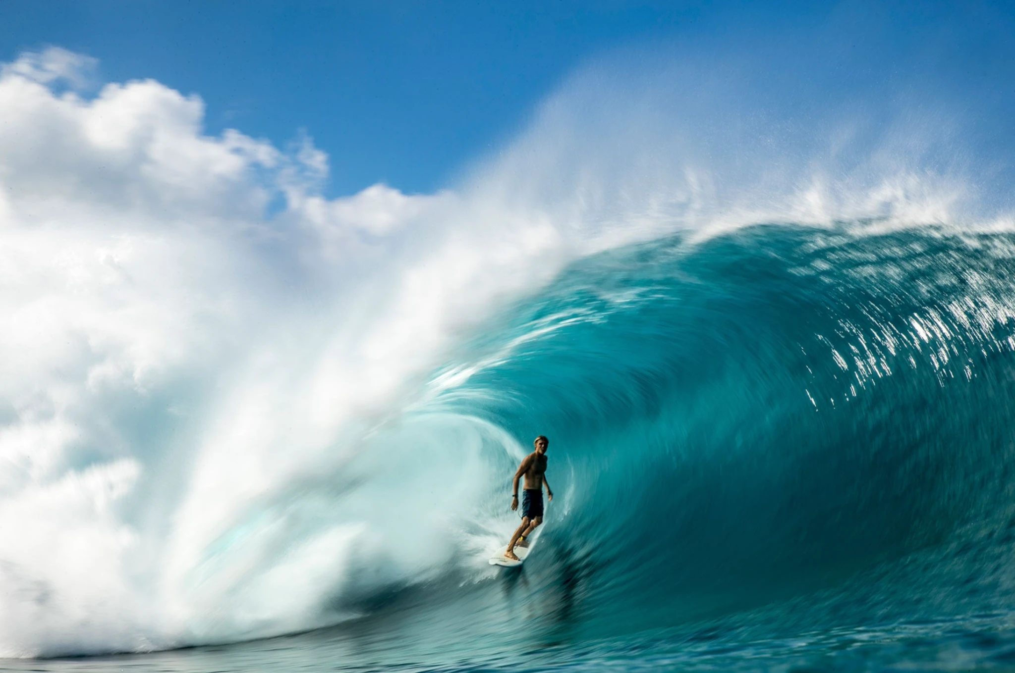 Koa Smith standing deep inside a turquoise barrel