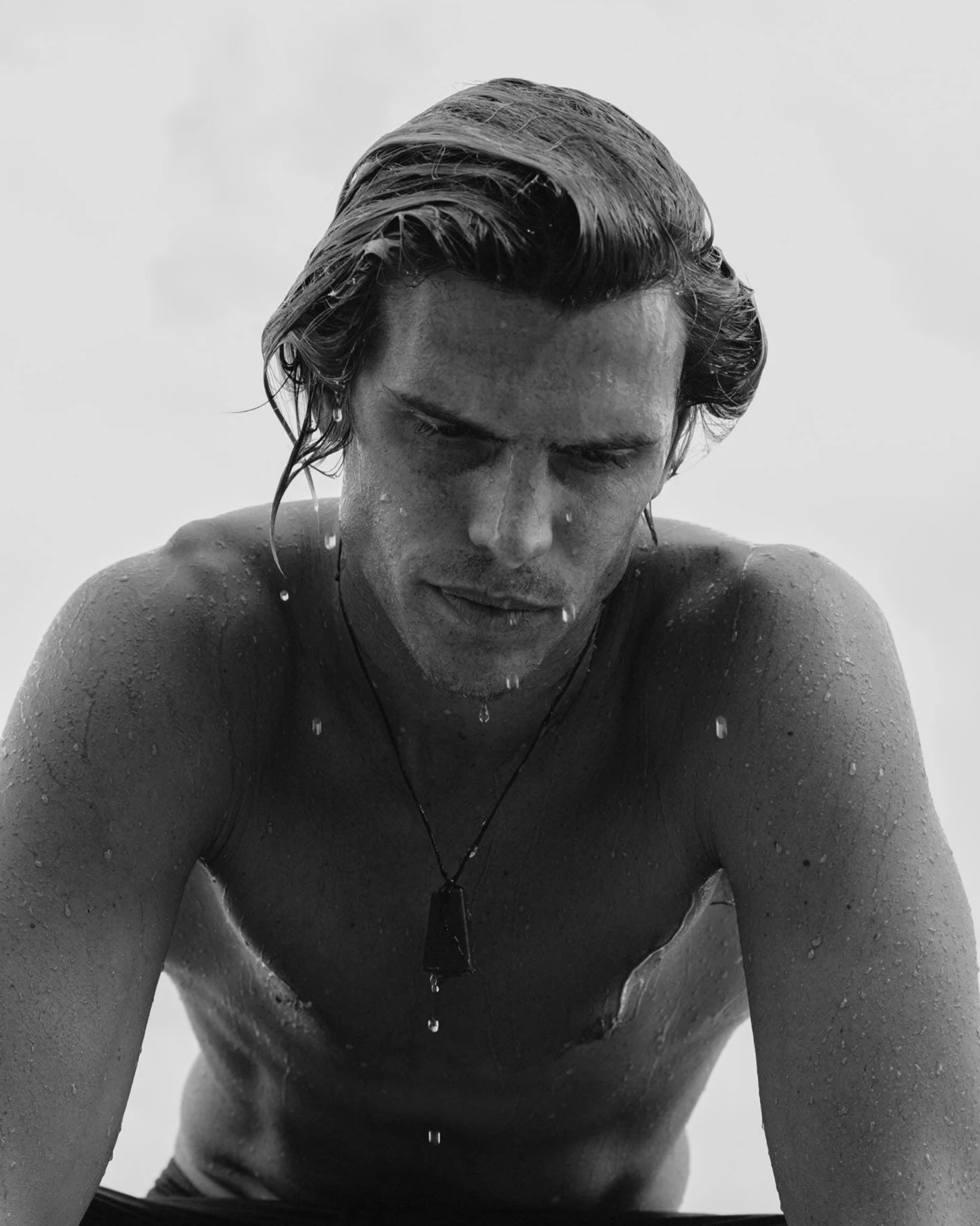 Black-and-white portrait of Koa Smith with water dripping from his face