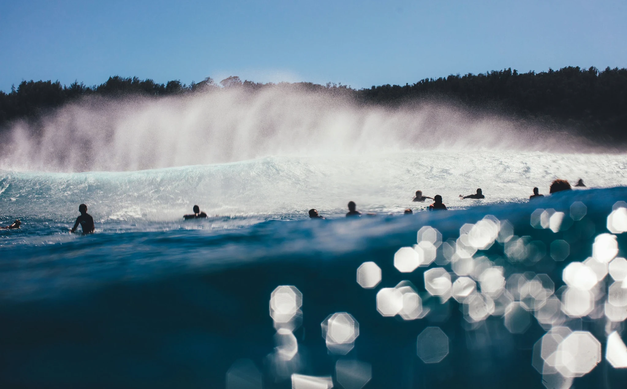 Surfers watching a powerful set from the Pipeline lineup